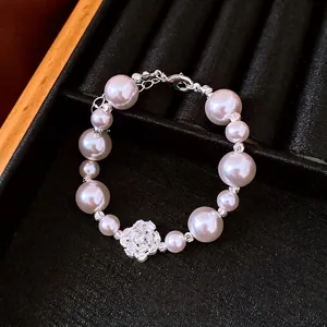 Vintage pearl bracelet with elegant zircon flower charm on black velvet display