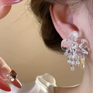 Elegant silver needle resin flower tassel earrings with sparkling zircon detail on model