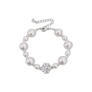 Elegant vintage pearl bracelet featuring a central zircon flower and adjustable metal chain