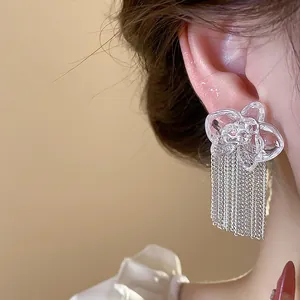 Exquisite resin flower earrings with metal tassels shown in a close-up detail view