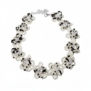 Vintage lace choker necklace featuring white flowers, black beads, and crystal centers