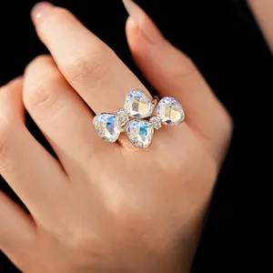 Close-up detail of an elegant sparkling crystal bow tie open ring worn on a finger