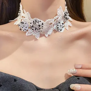 Detailed close-up view of elegant white lace floral choker with black glass beads.