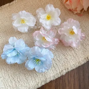Set of delicate fabric flower hair clips in white pink and blue colors
