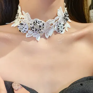 Close-up detail of elegant white lace floral choker necklace with black and white beads