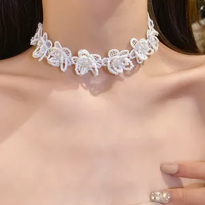 Detailed close-up showing white lace flower choker necklace with delicate glass beads