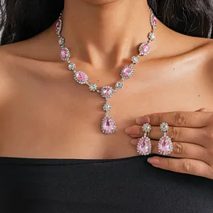 Detailed view of luxury pink crystal teardrop necklace and earrings set on model