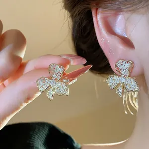 Detail shot of 18K gold plated flower earrings with exquisite micro-paved crystals