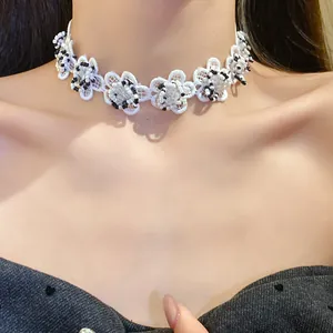 Close-up detail of vintage white lace flower choker necklace with beads on model neck