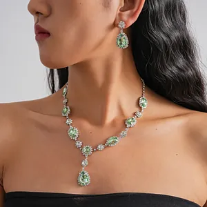 Detail view of a luxury vintage palace style green rhinestone necklace earring set