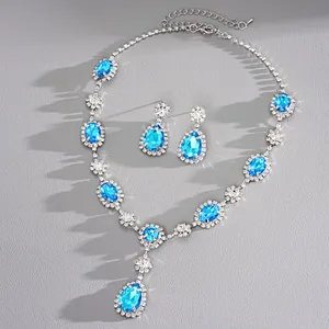 Detail of vintage style necklace and earrings set with blue teardrop stones