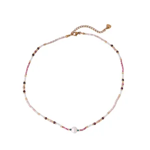 Elegant French style beaded necklace with a central pearl accent on white background