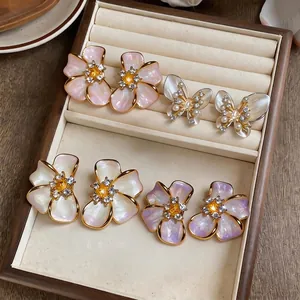 Elegant French vintage floral and butterfly stud earrings with pearl shell finish