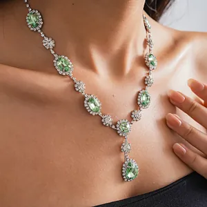 Close-up detail of elegant vintage palace style necklace with green teardrop gemstones