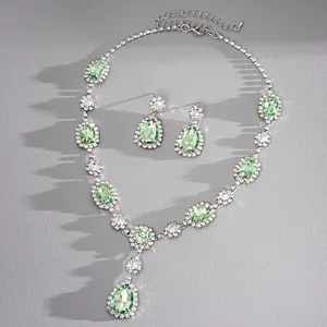 Exquisite detail of vintage green teardrop gemstone necklace and earring jewelry set