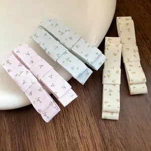 Sweet Korean style fabric bow hair clips with floral prints for vacation hair styling