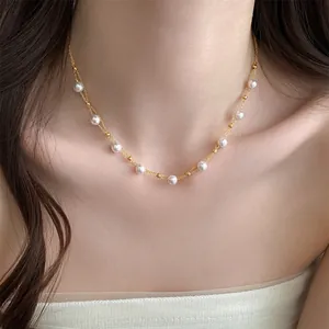 Detailed close-up view of a French luxury pearl necklace worn on a woman's collarbone.