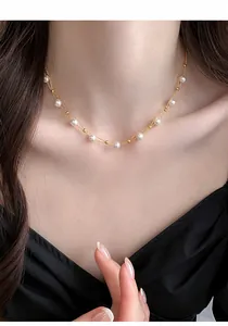 Detailed view of elegant French style double-layer pearl necklace on model's neck