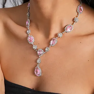 Close-up of vintage palace style necklace with pink crystal oval and teardrop pendants