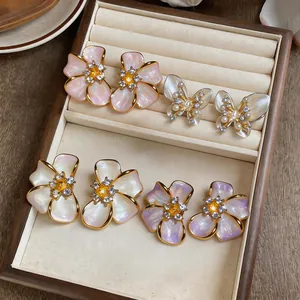 Detailed view of French light luxury pearl flower and butterfly stud earrings set