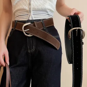 Close-up detail of vintage leather belts with unique zigzag stitching and silver buckles