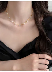 Detailed close-up showing a French style minimalist pearl choker necklace on model's neck