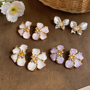 Elegant French style floral and butterfly stud earrings with sparkling crystals.