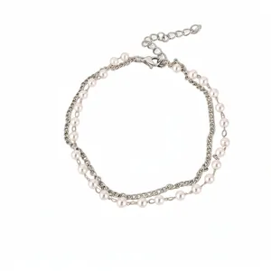 Double-layer pearl bracelet with silver metal chain, elegant minimalist jewelry design