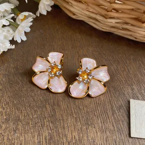 Macro view of elegant French luxury pearl flower stud earrings with crystal center