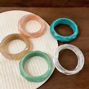 Selection of multi-colored faceted acrylic bangles featuring a retro geometric design