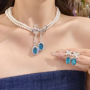 Ensemble collier et boucles d'oreilles en perles à deux rangs avec nœud
