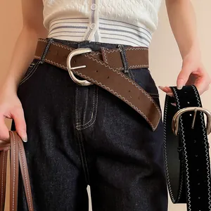 Detailed view of wide vintage belts with zig-zag stitching and silver buckles in brown and black.