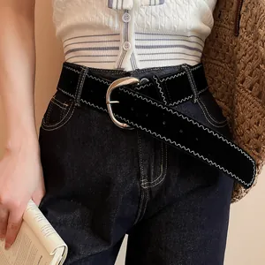 Detailed shot of a vintage black leather belt with white zigzag stitching decoration