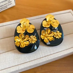 Vintage New Chinese style earrings with golden flower accents on black resin bases