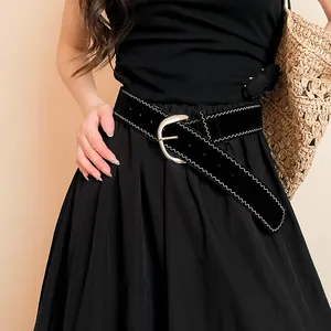 Close-up of black leather belt featuring white zigzag stitching and silver oval buckle