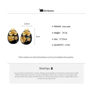 Close-up detail and specifications of vintage gold flower resin teardrop stud earrings
