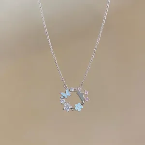 Silver necklace with butterfly and flower pendant decorated with zircons and blue enamel