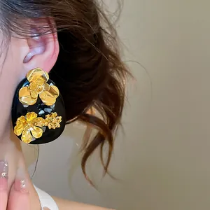 Close-up of vintage golden flower resin stud earrings with elegant New Chinese design