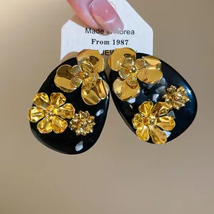 Close-up view of retro gold flower resin earrings with elegant Chinese style design