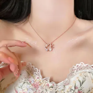 Elegant rose gold zircon butterfly and shell flower wreath necklace worn on a model