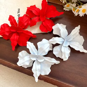 Large red and white spray-painted flower stud earrings featuring a stylish matte finish.