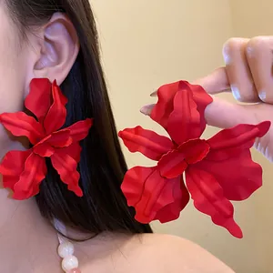 Large red matte flower stud earrings with wavy petals for a bold fashion statement.