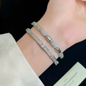 Elegant pair of 18K gold plated silver bangles with pavé cubic zirconia on wrist