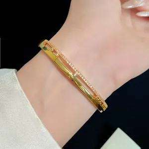 Close-up of 18K gold-plated double-layer oval bangle with shimmering zircon stones