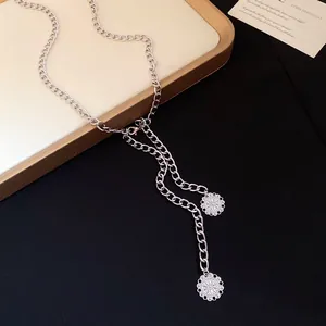 Elegant silver metal chain belt featuring two delicate circular openwork flower pendants