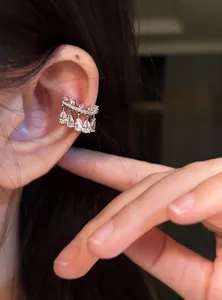Close-up of elegant silver zircon teardrop ear cuff showing refined craftsmanship.