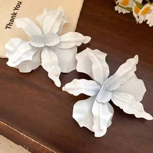Detailed macro view of elegant white matte flower stud earrings with multi-layered petals