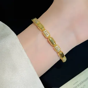 Close-up detail of luxury 18K gold plated bracelet with oval cubic zirconia on wrist