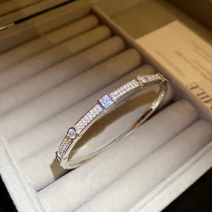 Detailed close-up view of an elegant 18K gold plated zircon pavé bangle in a jewelry box