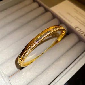 Close-up of 18K gold plated double-layer oval bangle with cubic zirconia details